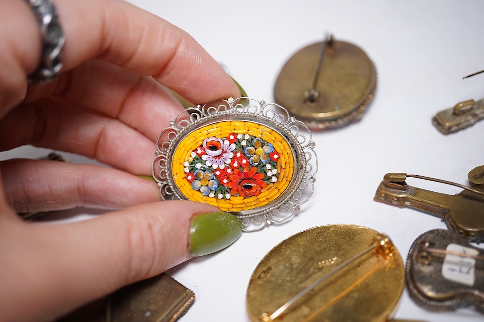 A collection of twenty-eight micro-mosaic brooches, including ten banjo and guitars shaped brooches, six similar large oval brooches, nine small brooches and three long brooches. (28) Condition - good